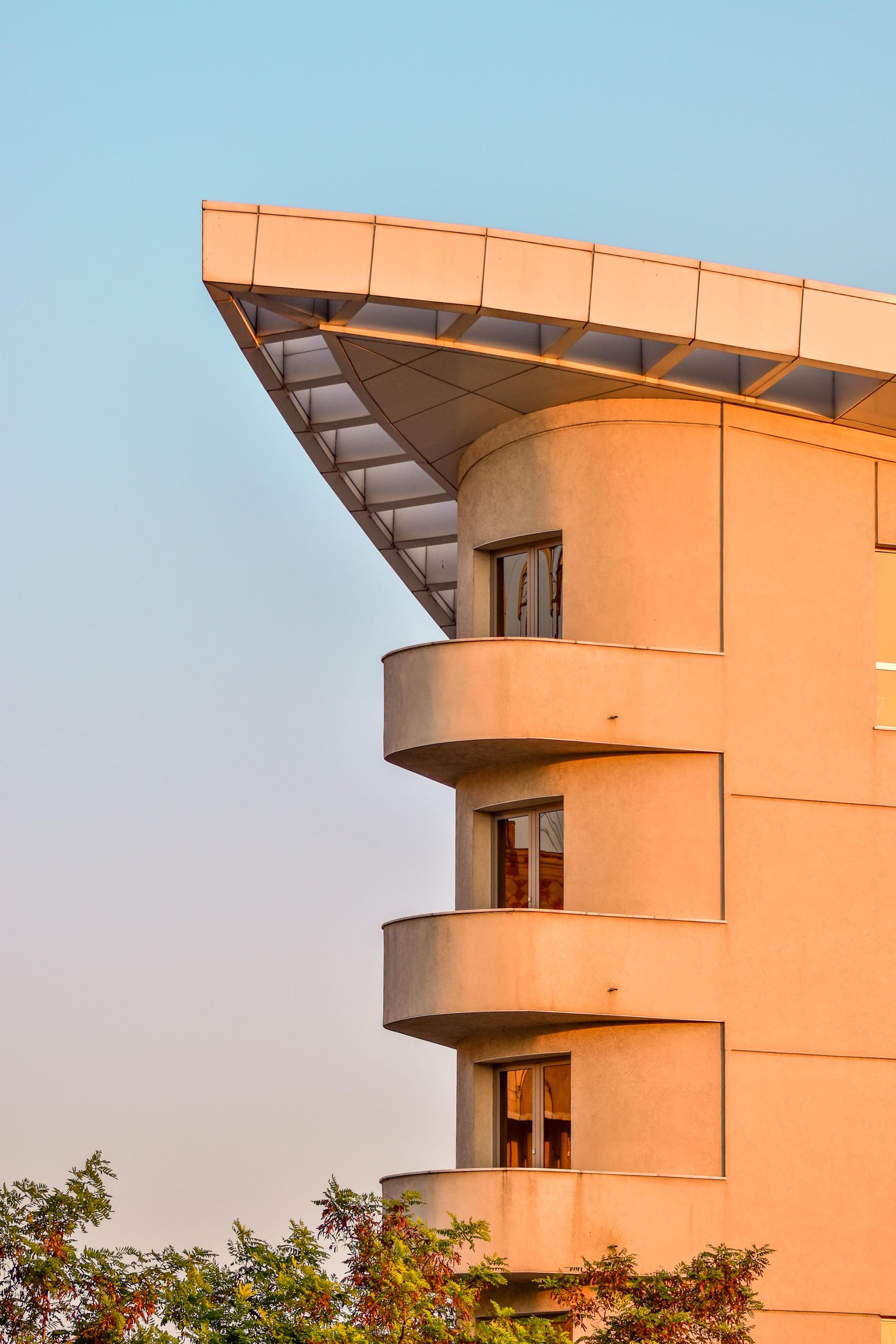 Close-up of a modern apartment building showcasing distinct architectural features and rounded balconies.